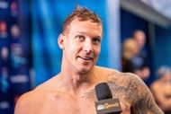 Caeleb Dressel looks on after winning the Men's 100 Meter Butterfly Final at the Toyota US Open at the Greensboro Aquatic Center in Greensboro, North Carolina.